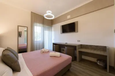 a bedroom with a bed with two towels on it at Hotel Casa Tra Noi in Rome