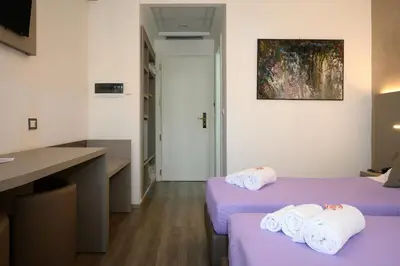 a hotel room with two beds with towels on them at Hotel Casa Tra Noi in Rome
