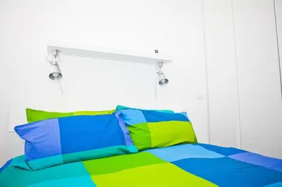 a bed with colorful pillows in a bedroom at Viale Trastevere 108 in Rome