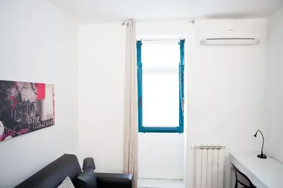 a living room with a couch and a window at Viale Trastevere 108 in Rome