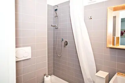 a bathroom with a shower with a white shower curtain at Viale Trastevere 108 in Rome