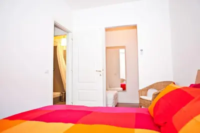a bedroom with a bed with a colorful blanket at Viale Trastevere 108 in Rome