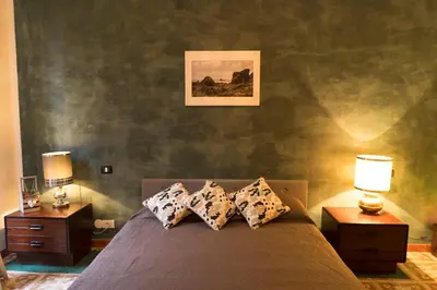 a bedroom with a bed with two night stands and two lamps at Trastevere Corner Eight in Rome