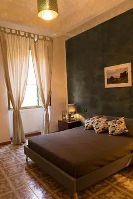 a bedroom with a large bed and a window at Trastevere Corner Eight in Rome