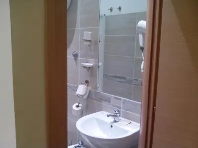 a bathroom with a white sink and a shower at Guest House Hola Roma in Rome