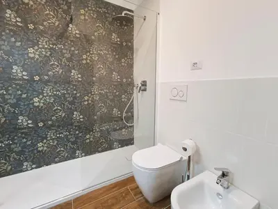 a bathroom with a shower and a toilet and a sink at La tua casa a ViadelCorso in Rome
