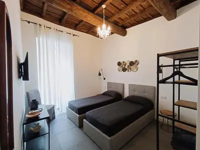 a bedroom with two beds and a bunk bed at La tua casa a ViadelCorso in Rome