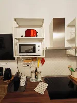 a kitchen with a microwave on top of a counter at La tua casa a ViadelCorso in Rome