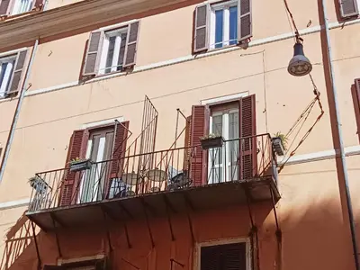 a building with balconies and windows on a street at La tua casa a ViadelCorso in Rome