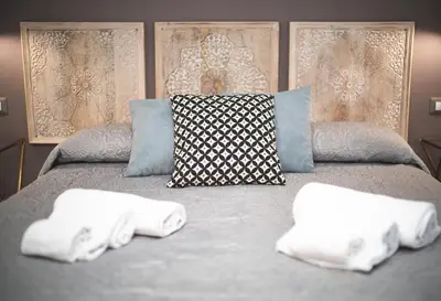 a bed with two folded towels on top of it at Verrazzano 37 Guest House in Rome