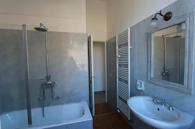 a bathroom with a tub and a sink and a shower at Art Atelier San Pietro in Rome