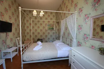 a bedroom with a canopy bed with white pillows at Art Atelier San Pietro in Rome