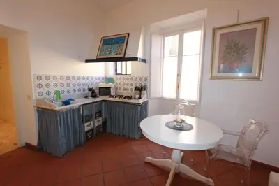 a kitchen with a white table and a white table at Art Atelier San Pietro in Rome