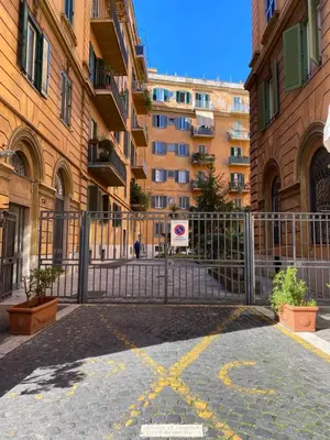 a gate in the middle of a city with buildings at Art Atelier San Pietro in Rome