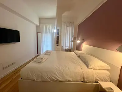 a hallway with two beds and a wooden floor at Atelier San Pietro in Rome