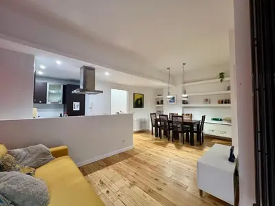 a living room and kitchen with a couch and a table at Atelier San Pietro in Rome