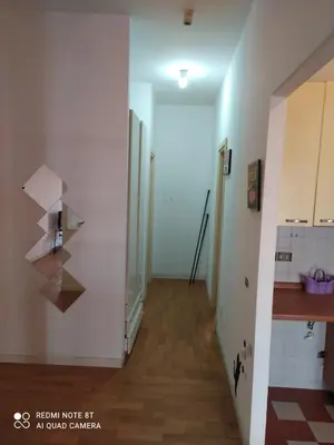 a hallway of a room with a kitchen and a stairway at Marco's House in Rome