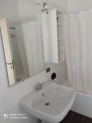 a bathroom with a white sink and a mirror at Marco's House in Rome