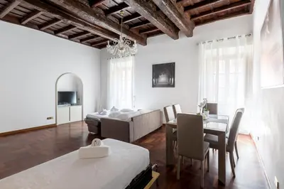 a living room with a bed and a dining room at A World Aparts - 143 Sistina in Rome