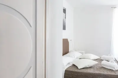 a bedroom with a bed with white pillows on it at A World Aparts - 143 Sistina in Rome