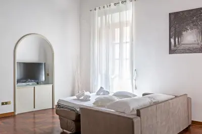 a living room with a couch in front of a window at A World Aparts - 143 Sistina in Rome