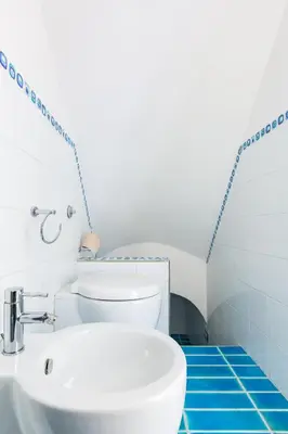 a bathroom with a white sink and a toilet at A World Aparts - 143 Sistina in Rome