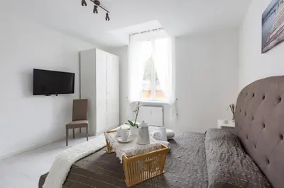 a living room with a couch and a tv at The Imperial Suite in Rome