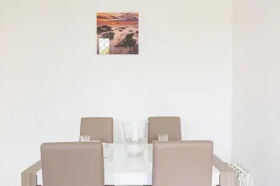 a white table with two chairs and a glass vase at The Imperial Suite in Rome