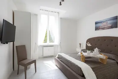 a bedroom with a bed and a table and a chair at The Imperial Suite in Rome