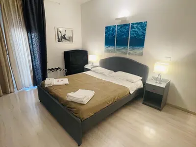 a bedroom with a bed with two towels on it at Tiburtina Suites, Roma in Rome