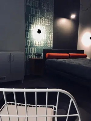 a bedroom with a bed and a crib at Tiburtina Suites, Roma in Rome