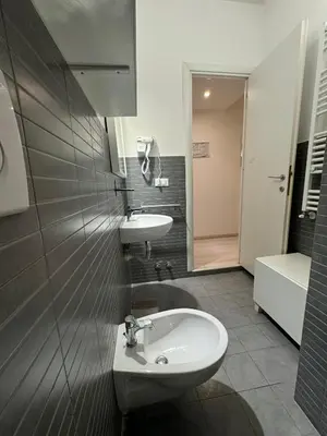 a bathroom with a sink and a toilet at Tiburtina Suites, Roma in Rome