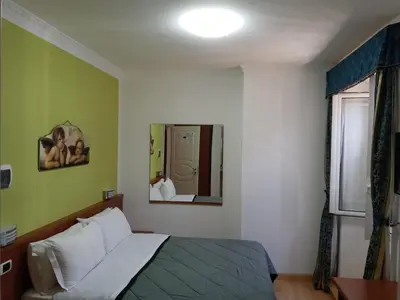 a bedroom with a bed and a mirror at La Casa Dell'Arte in Rome