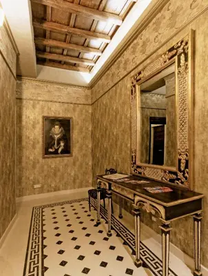 a bathroom with a vanity and a mirror on the wall at Antica Dimora De Michaelis in Rome