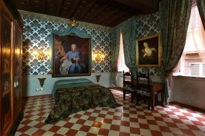 a bedroom with a painting on the wall and a bed at Antica Dimora De Michaelis in Rome