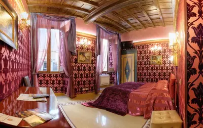 a bedroom with a bed and a table in it at Antica Dimora De Michaelis in Rome