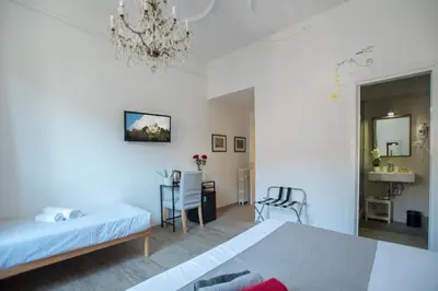 a bedroom with a bed and a table and chairs at Raffaela's Suite & Rooms Vatican Guest House in Rome