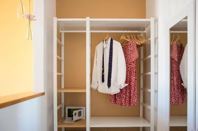 a walk in closet with clothes on racks at Raffaela's Suite & Rooms Vatican Guest House in Rome