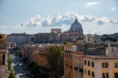 a view of a city with a dome in the background at Raffaela's Suite & Rooms Vatican Guest House in Rome