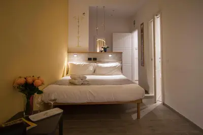 a bedroom with a bed with a teddy bear on it at Raffaela's Suite & Rooms Vatican Guest House in Rome