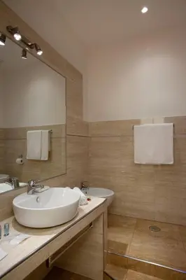 a bathroom with a sink and a tub and a mirror at Town House Fontana Di Trevi in Rome