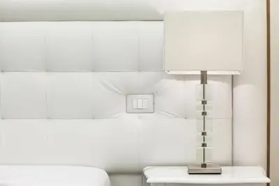a lamp on a table next to a bed at Town House Fontana Di Trevi in Rome