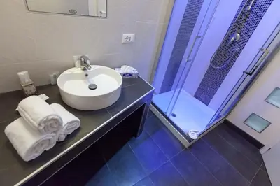 a bathroom with a sink and a shower at Town House Fontana Di Trevi in Rome
