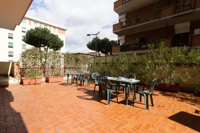 a group of tables and chairs on a brick patio at Pascià Rooms in Rome
