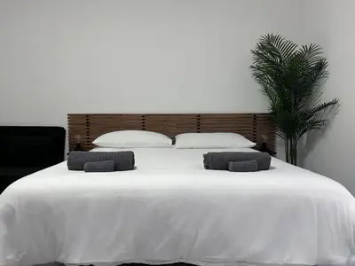 a large white bed with two pillows on it at Pascià Rooms in Rome