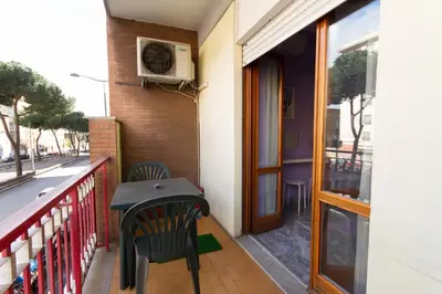 a table and chairs on a balcony with a heater at Pascià Rooms in Rome