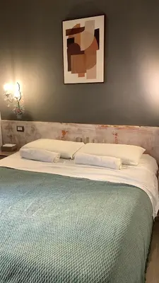 a bedroom with a large bed with white sheets at Domus Ferruccio in Rome