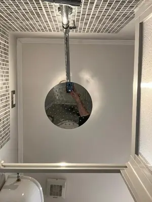 a light fixture hanging over a toilet in a bathroom at Domus Ferruccio in Rome