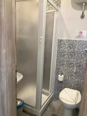 a bathroom with a shower with a toilet and a sink at Domus Ferruccio in Rome