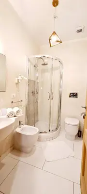 a small bedroom with a white bed and a window at I Dormienti in Rome
